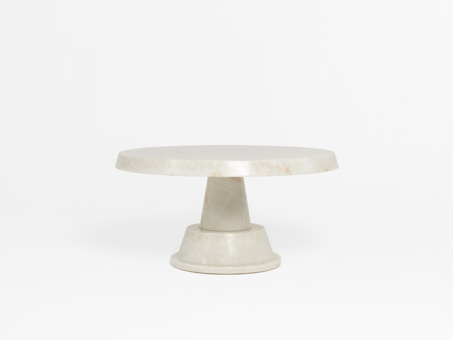 Round pale onyx pedestal table, translucent creamy top on a conical stem rising from a stepped tiered circular base — Pierre Augustin Rose Onyt
