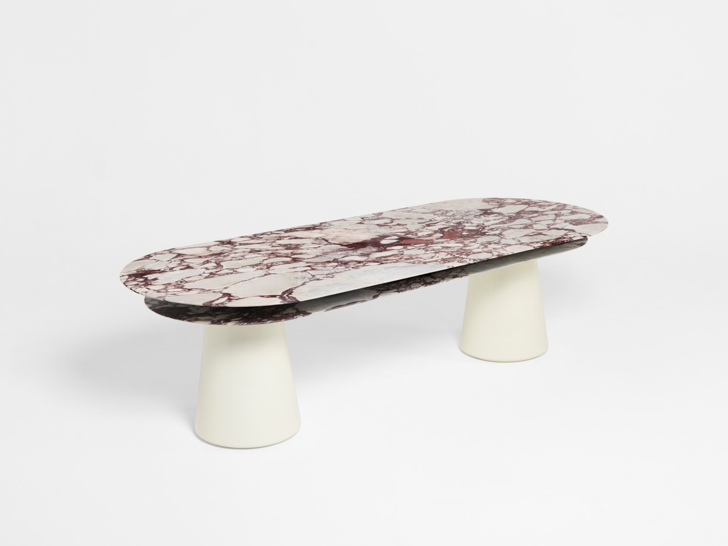 Oval dining table with veined Calacatta Viola marble top in burgundy and white on two conical cream bases — Pierre Augustin Rose Pietra Dining Table