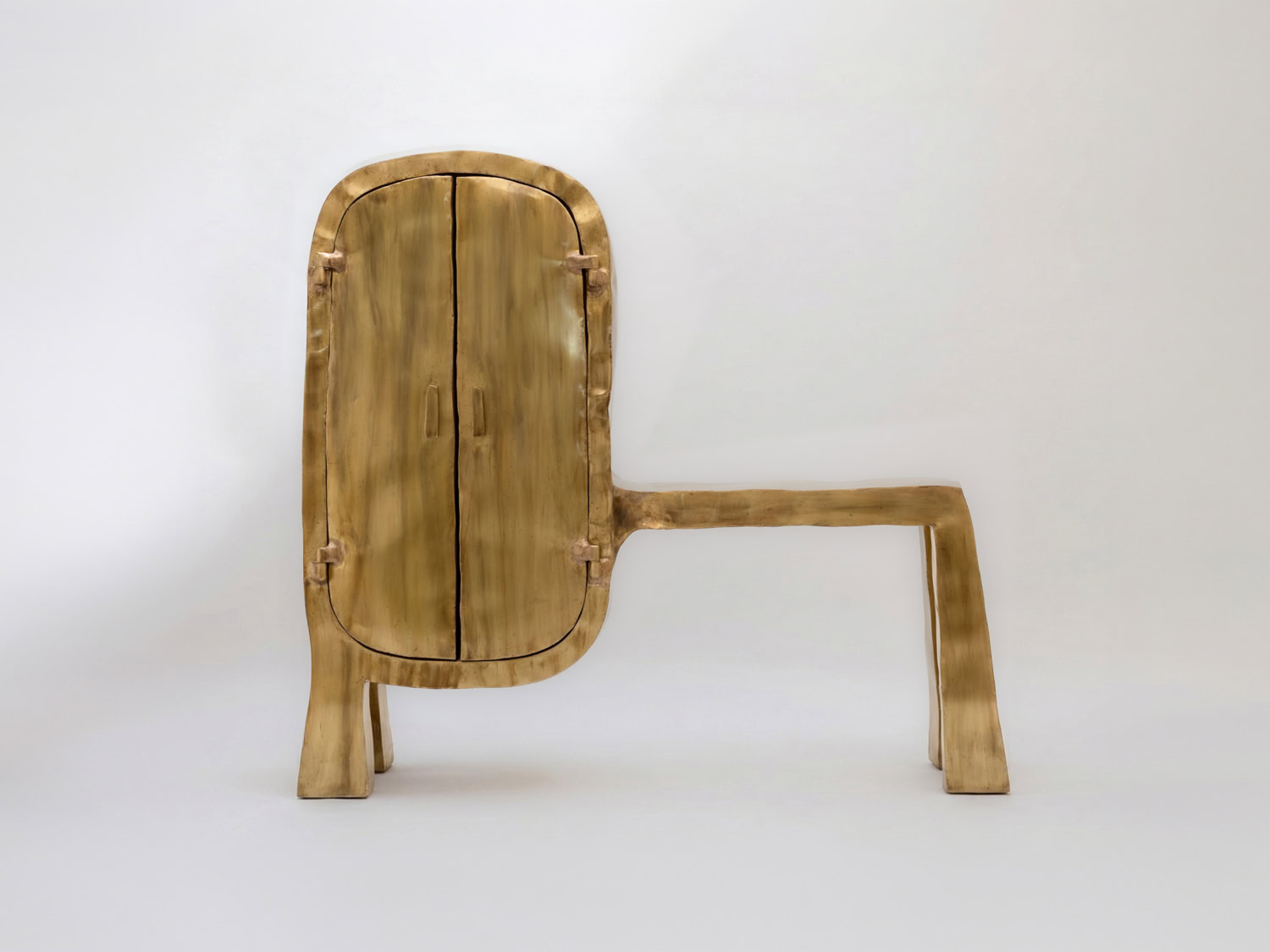 Sculptural brass drinking cabinet with a rounded double-door body on splayed legs and a long cantilevered bench arm — Nick Valentijn Drinking Cabinet